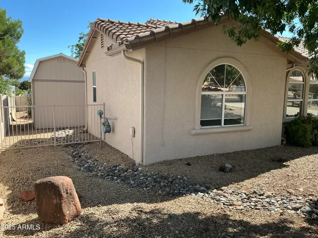 a wooden bench sitting in front of a house