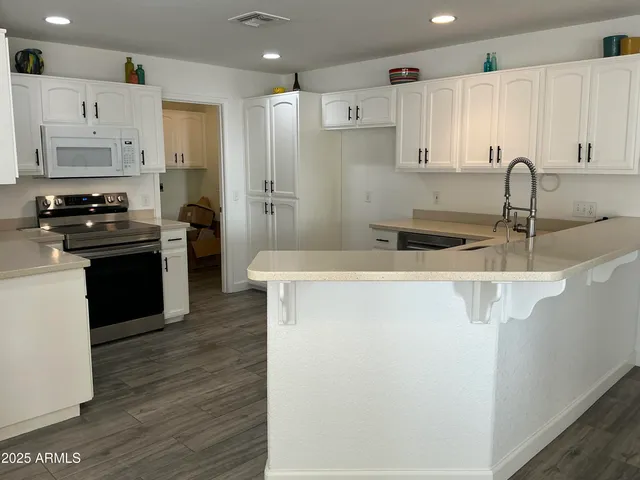 a kitchen with stainless steel appliances a refrigerator and a stove