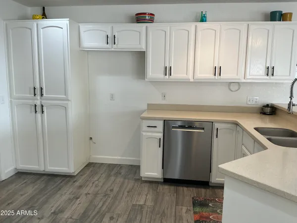 a kitchen with white cabinets and stainless steel appliances