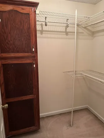 a living room with furniture a fireplace and a floor to ceiling window