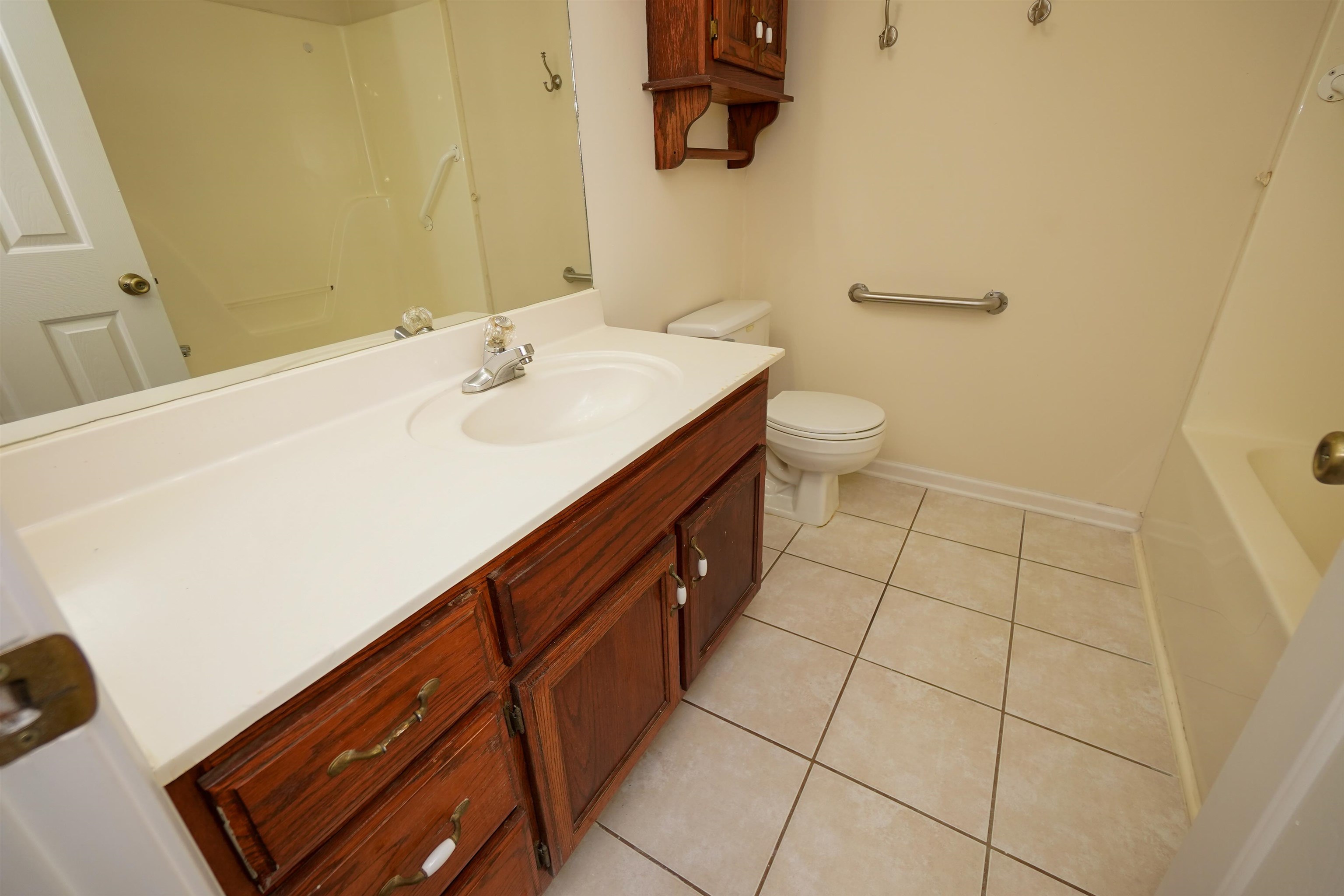 242 Timothy Road Atoka, TN 38004 - Photo 21 of 25 a spacious bathroom with a sink a toilet and a mirror