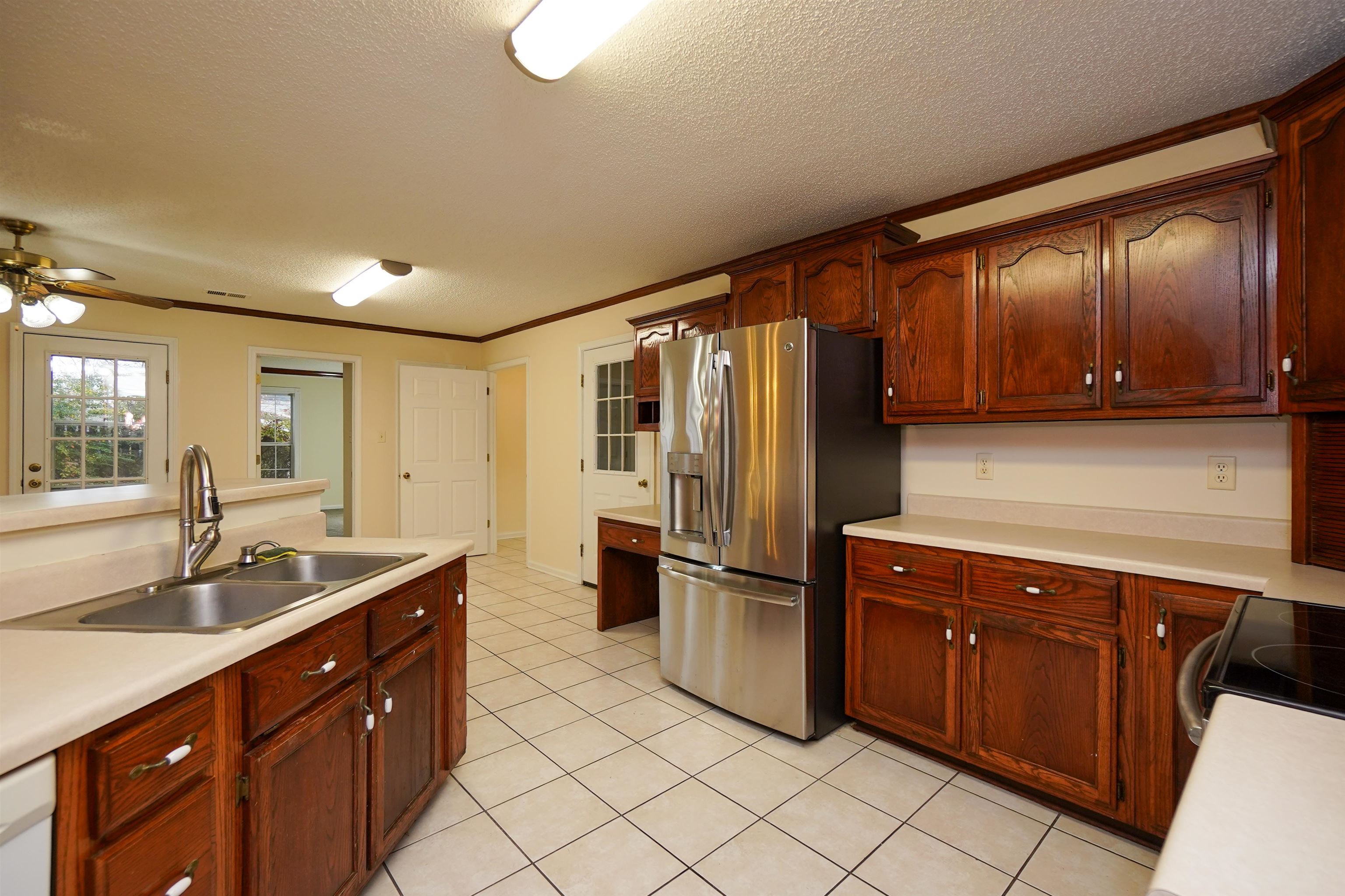 242 Timothy Road Atoka, TN 38004 - Photo 8 of 25 a kitchen with stainless steel appliances granite countertop a sink stove and refrigerator