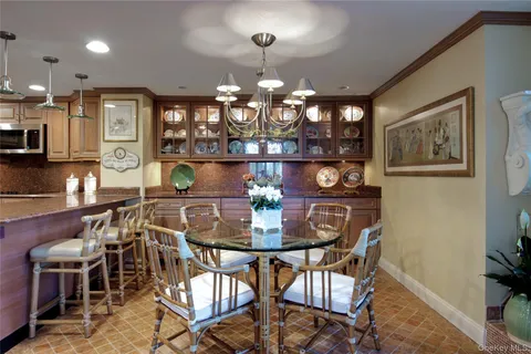 a view of a dining room with furniture and chandelier