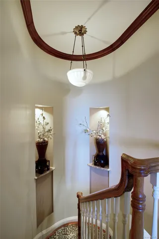 a view of a hallway to a livingroom with furniture