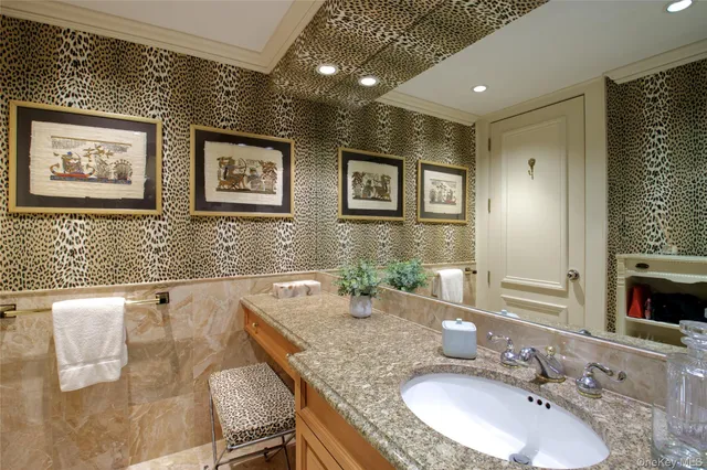 a bathroom with double vanity sinks a large mirror and a shower