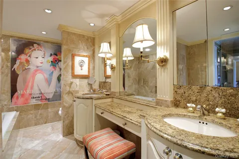 a bathroom with a granite countertop sink mirror and double