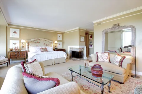 a bedroom with furniture and a fireplace