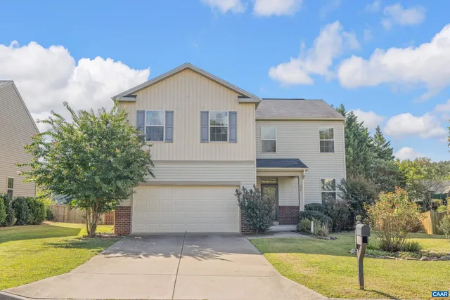 a front view of house with yard and trees