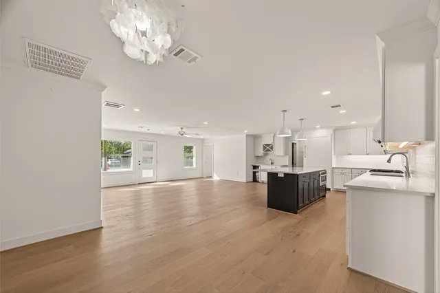a view of kitchen with kitchen island stainless steel appliances sink and living room view