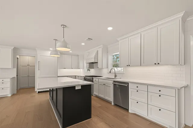 a kitchen with a sink window and cabinets