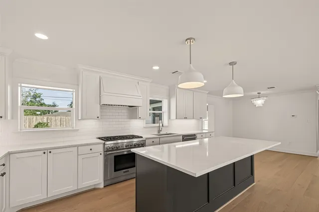 a kitchen with a sink a stove a microwave and cabinets