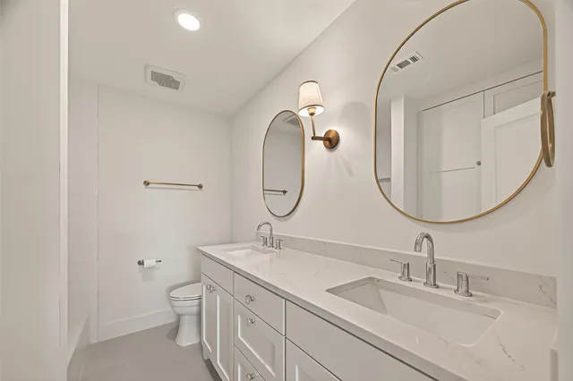 an empty room with a window and a ceiling fan