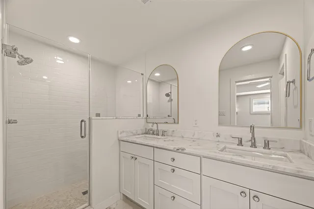 a bathroom with a granite countertop sink mirror and double