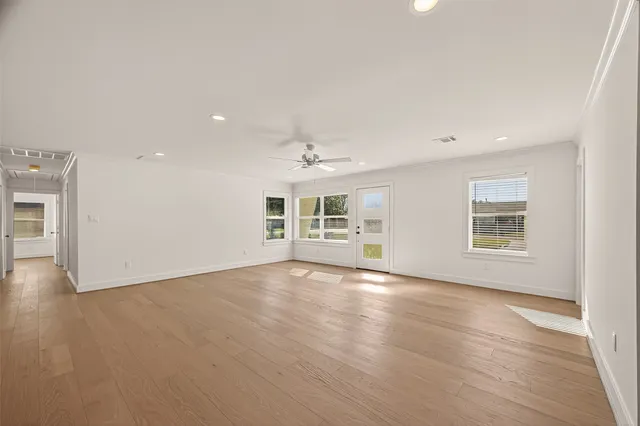 wooden floor in an empty room with a window