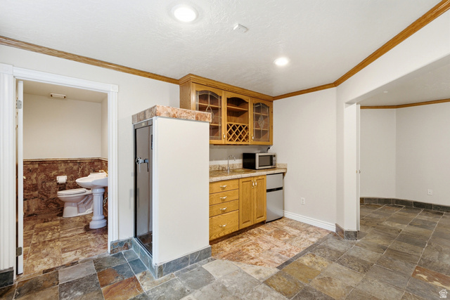 3535 Homestead Road Park City, UT 84098 - Photo 50 of 81 Entertainment area featuring a wet bar with wood cabinetry, a built-in wine rack, and a stone-look countertop