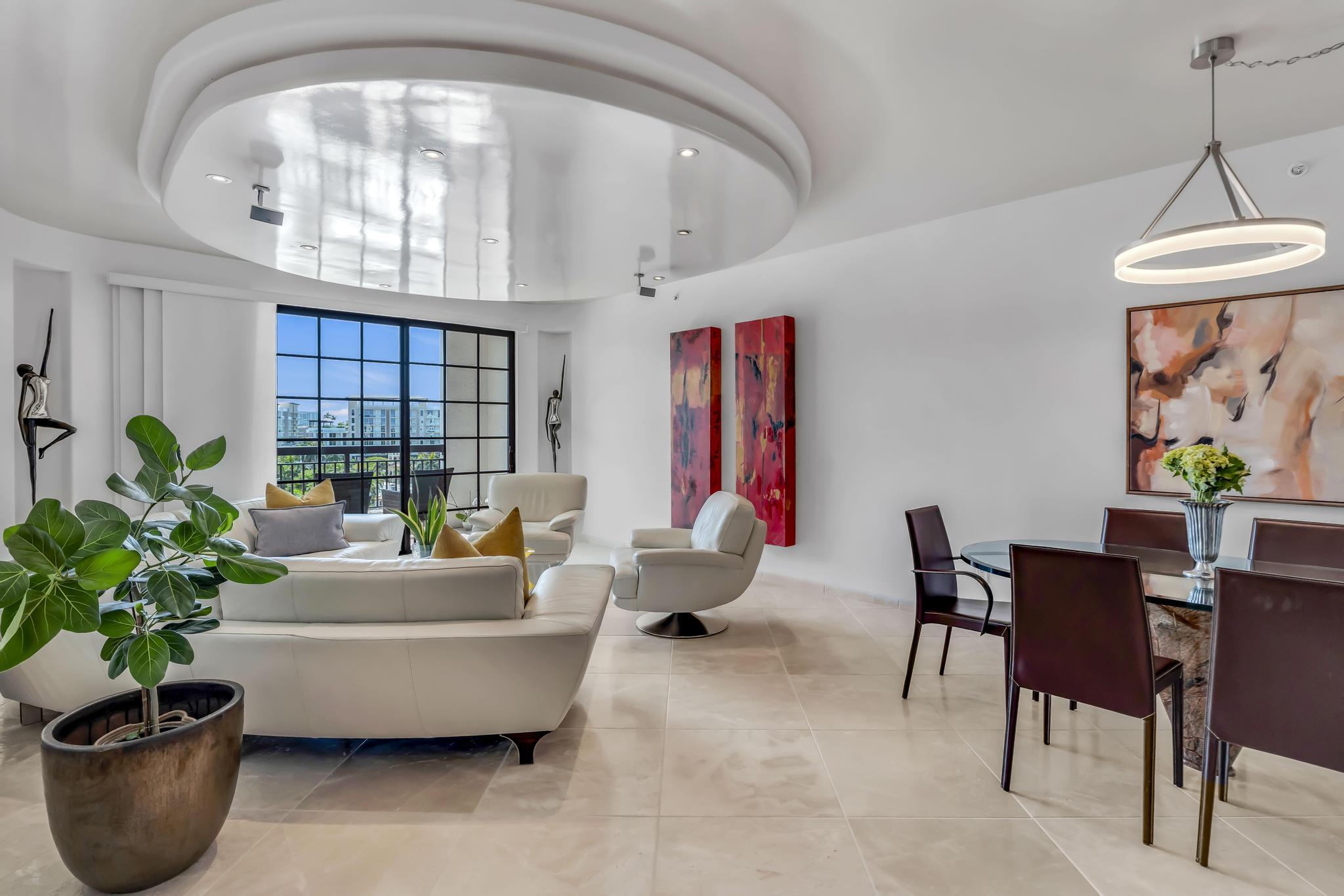 a living room with furniture and a potted plant