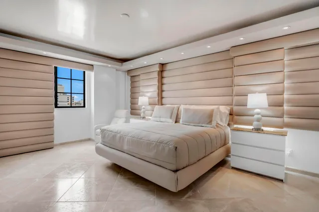 a bedroom with a bed couch and a dresser