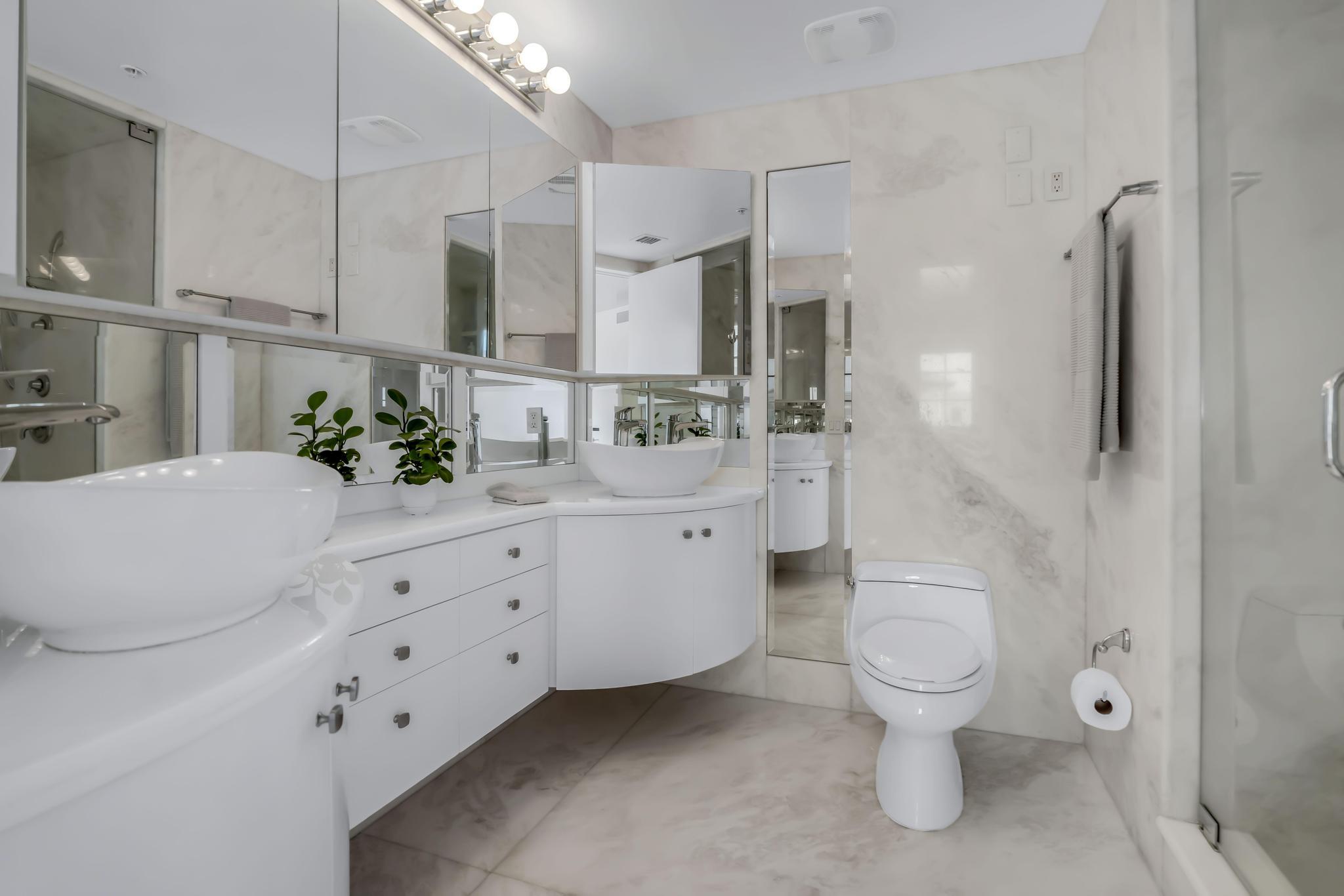 233 South Federal Highway, Unit 709 Boca Raton, FL 33432 - Photo 20 of 64 a spacious bathroom with a double vanity sink toilet and shower