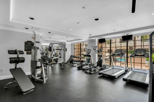 a living room with furniture a flat screen tv and wooden floor