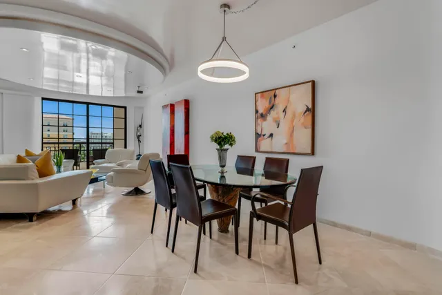 a view of a dining room with furniture and chandelier