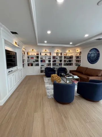 a living room with furniture and a book shelf