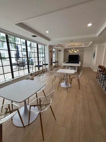 a view of a dining room with furniture wooden floor and chandelier