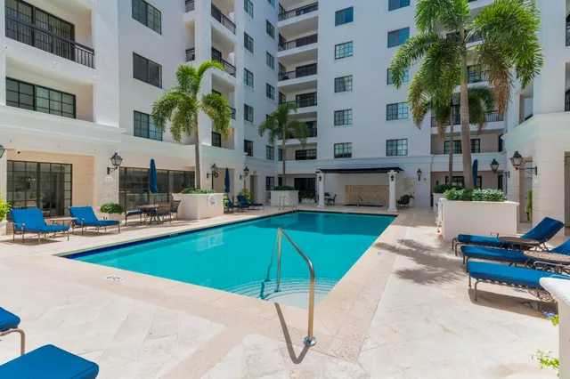 a dining room with furniture and a large window