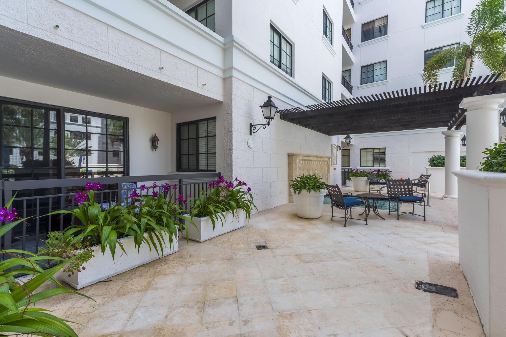 233 South Federal Highway, Unit 709 Boca Raton, FL 33432 - Photo 52 of 64 a view of a patio with table and chairs and potted plants