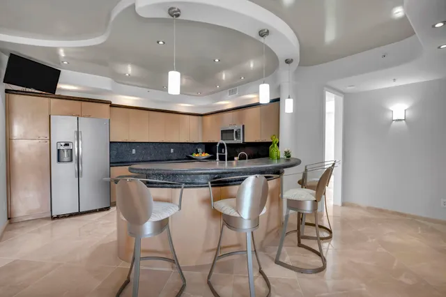 a kitchen with stainless steel appliances granite countertop a sink and cabinets