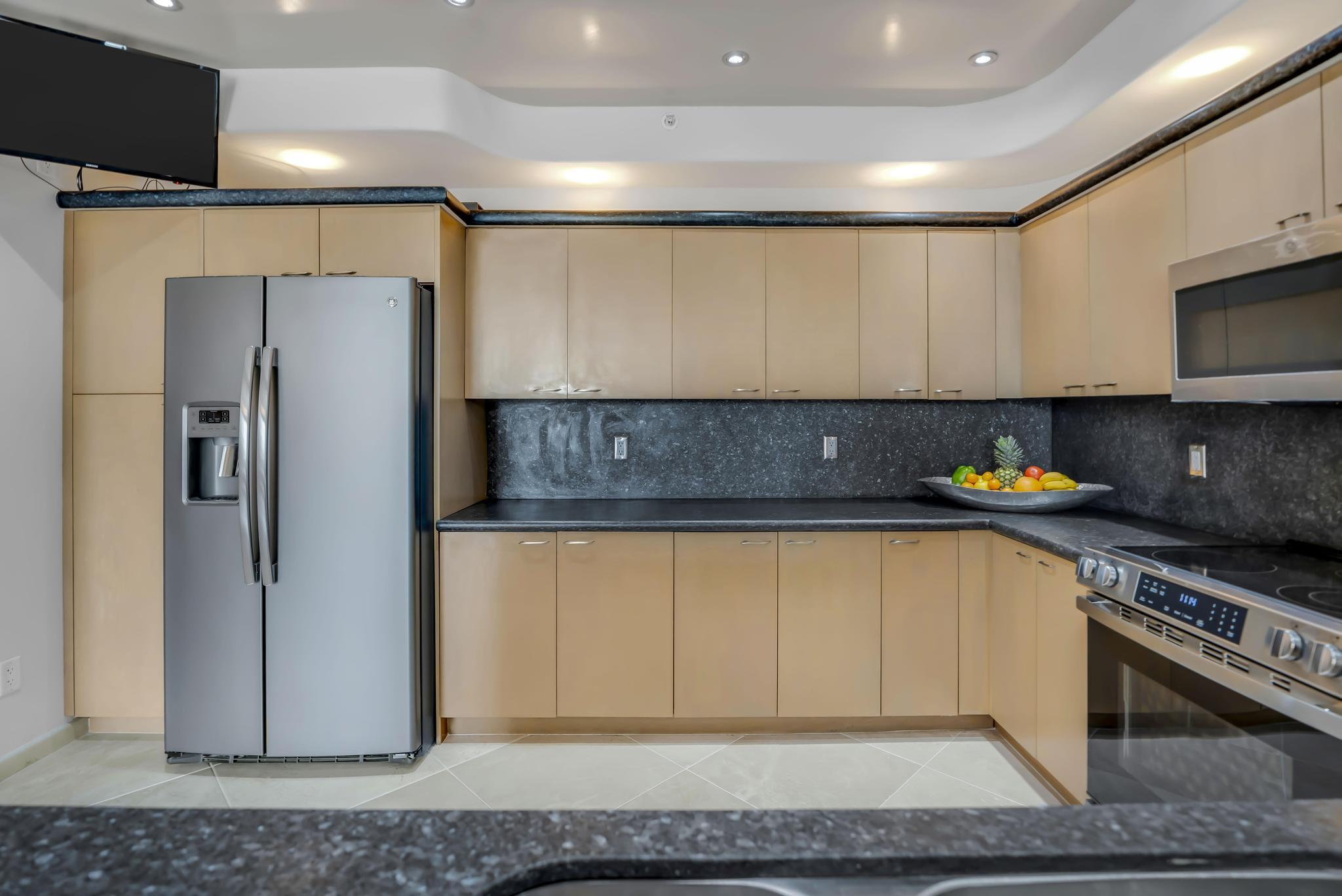 233 South Federal Highway, Unit 709 Boca Raton, FL 33432 - Photo 10 of 64 a kitchen with stainless steel appliances granite countertop a refrigerator a stove and a sink with wooden floor