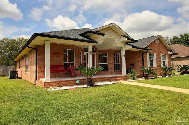 a view of a house with a yard and plants
