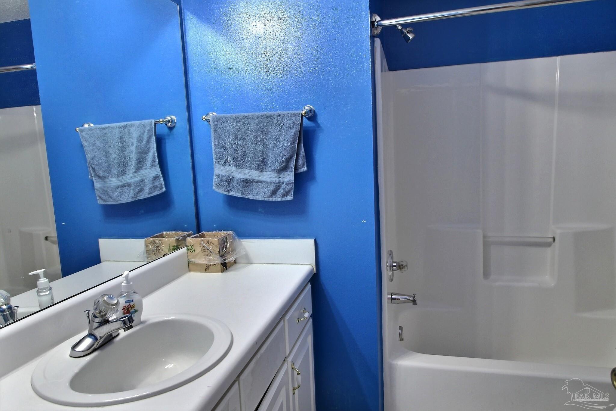 213 Newberry Street Cantonment, FL 32533 - Photo 11 of 23 a bathroom with a sink and a mirror
