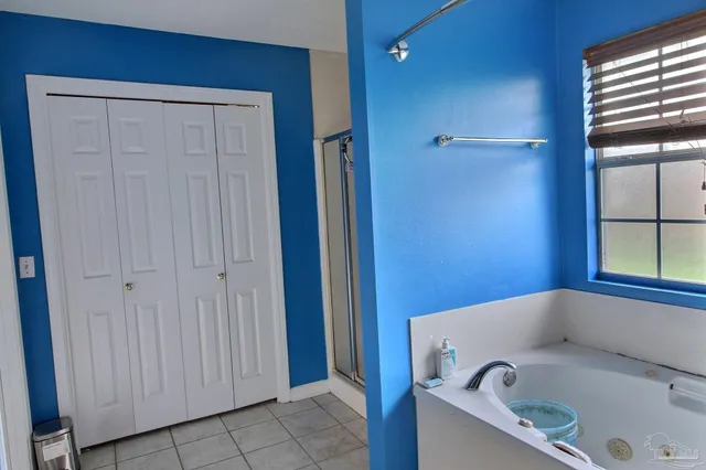 a bathroom with a tub and shower