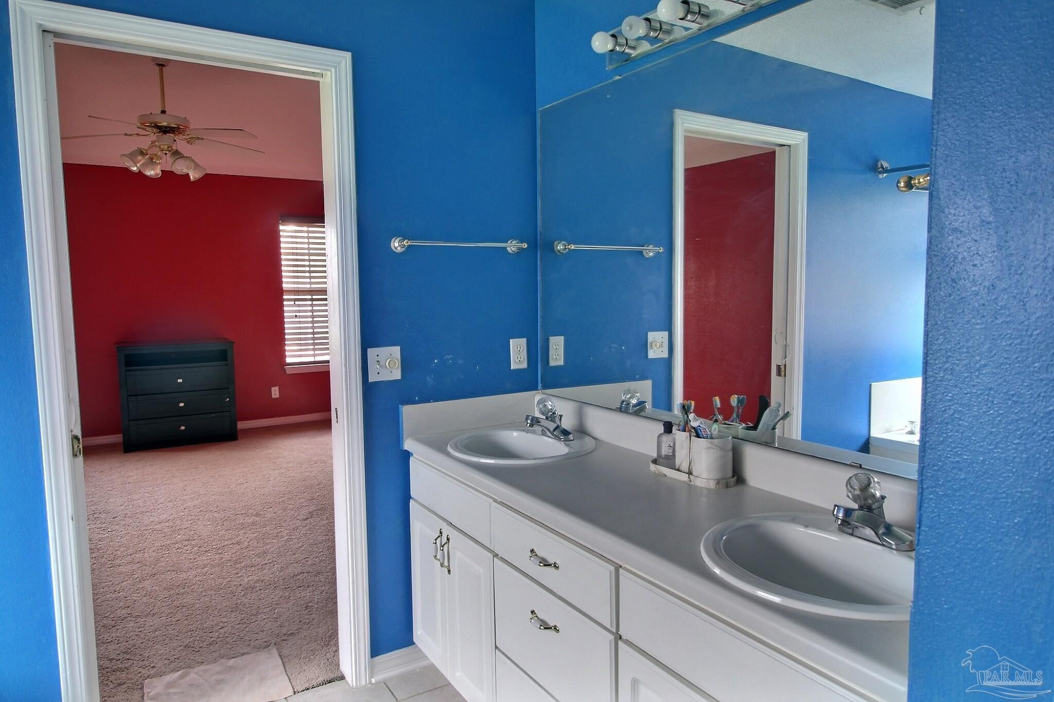213 Newberry Street Cantonment, FL 32533 - Photo 16 of 23 a bathroom with a sink and a mirror