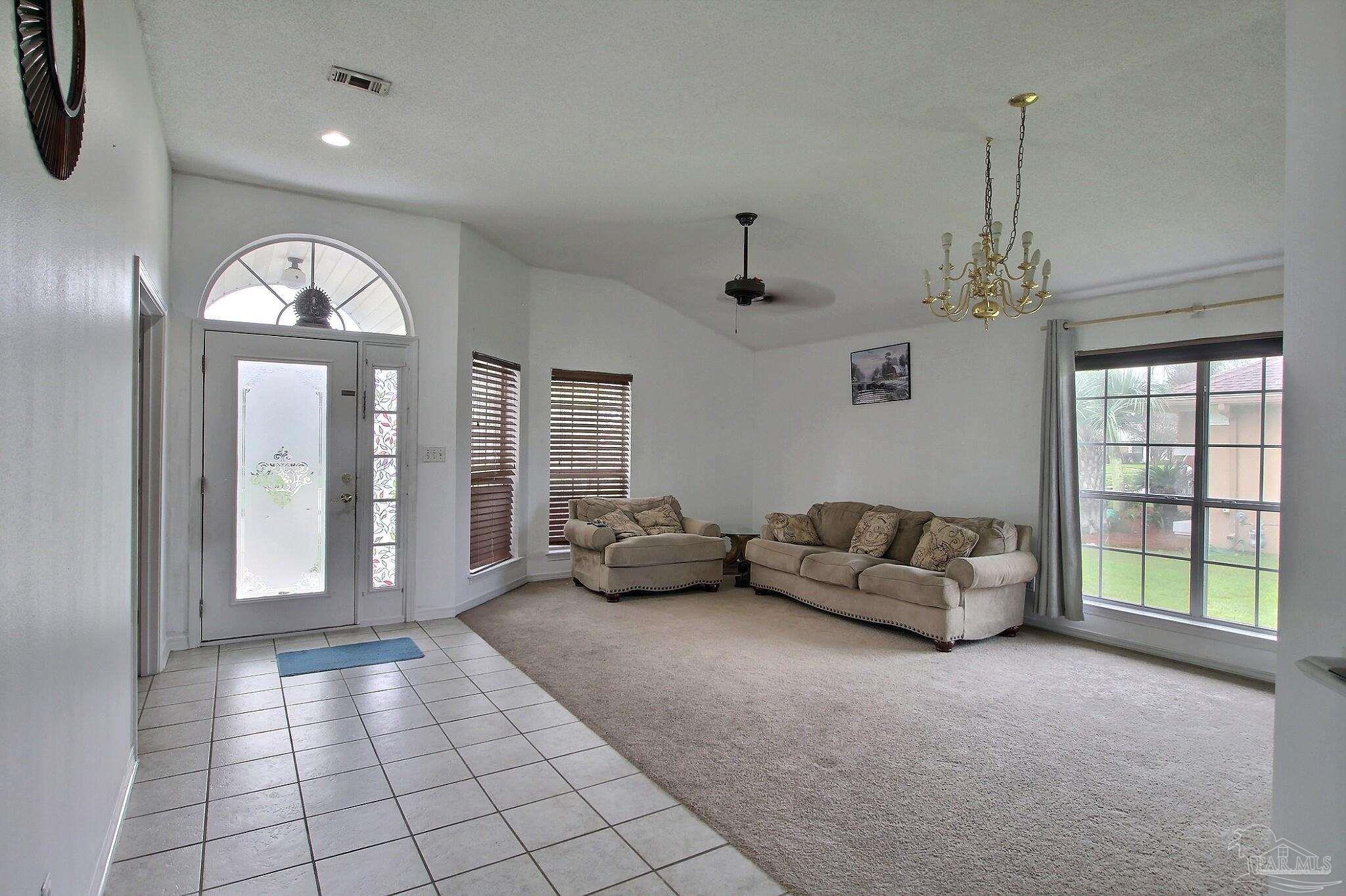 213 Newberry Street Cantonment, FL 32533 - Photo 2 of 23 a living room with furniture and a large window
