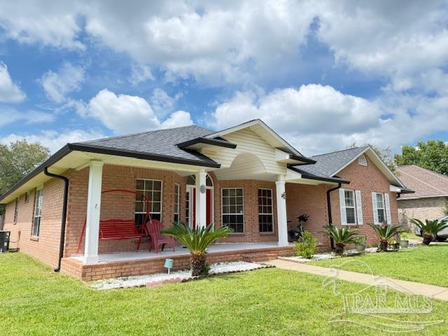213 Newberry Street Cantonment, FL 32533 - Photo 22 of 23 a front view of a house with a yard