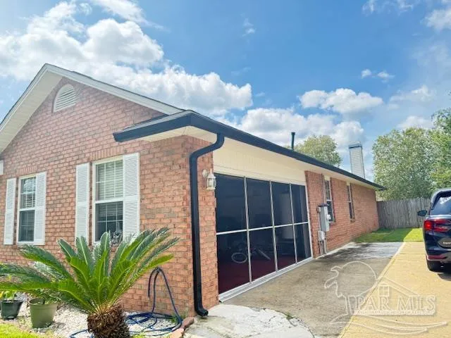a view of a house with a backyard and potted plants
