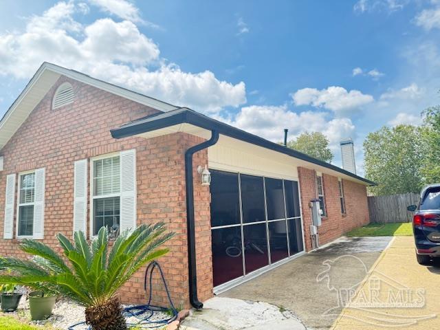 213 Newberry Street Cantonment, FL 32533 - Photo 23 of 23 a view of a house with a backyard and potted plants
