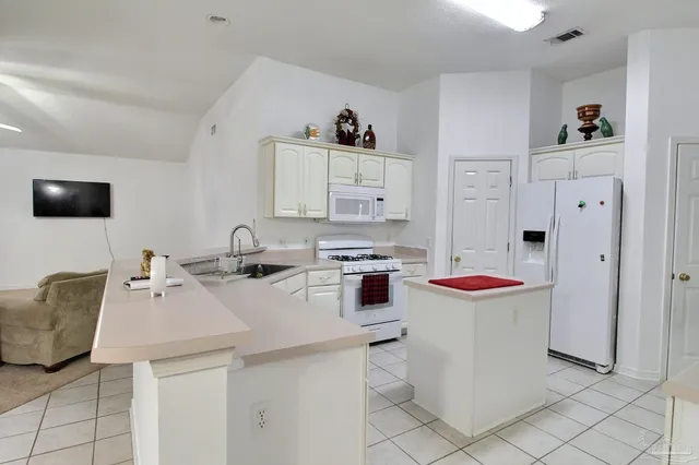 a kitchen with a sink and a stove top oven