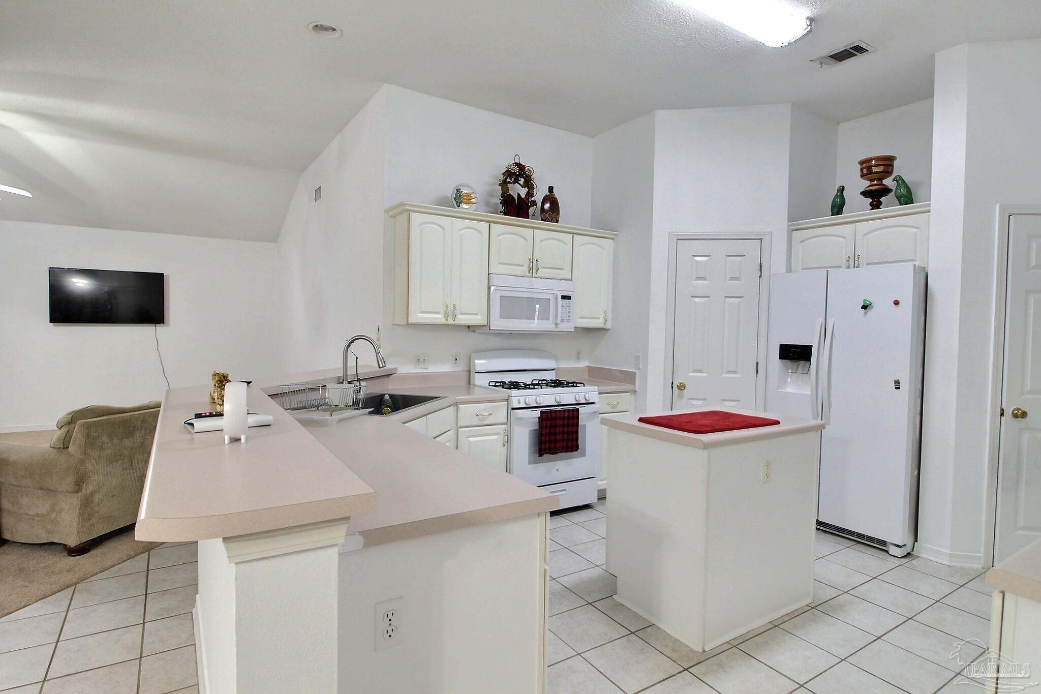 213 Newberry Street Cantonment, FL 32533 - Photo 4 of 23 a kitchen with a sink and a stove top oven