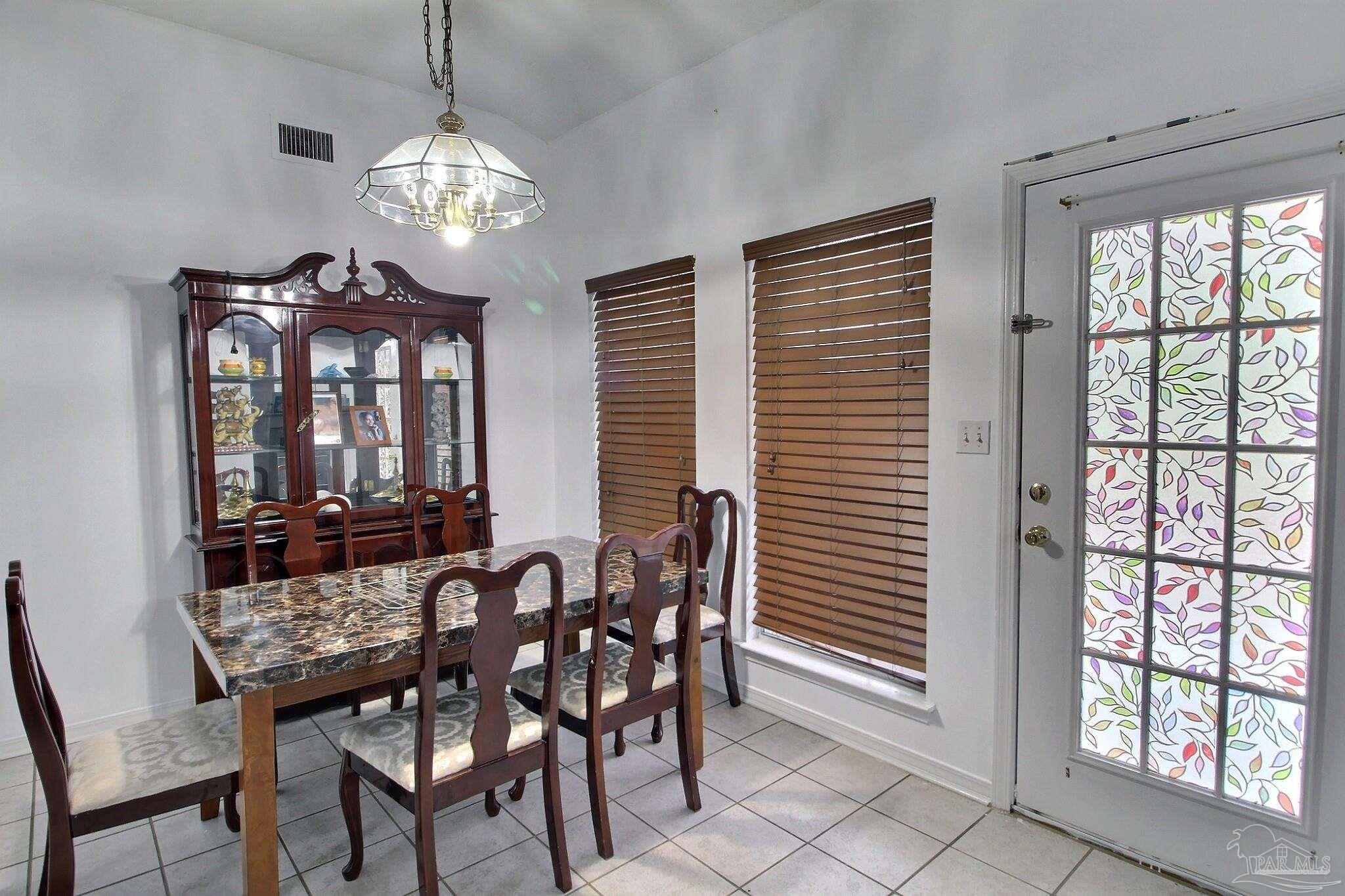 213 Newberry Street Cantonment, FL 32533 - Photo 9 of 23 a view of a dining room with furniture and window
