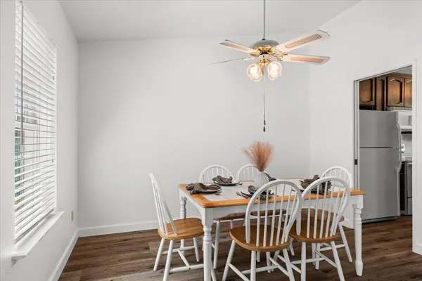 a view of a dining room with furniture and wooden floor