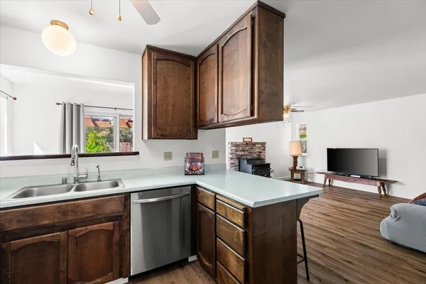 a kitchen with a sink cabinets and wooden floor