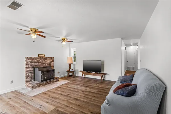 a view of a livingroom with furniture and a flat screen tv