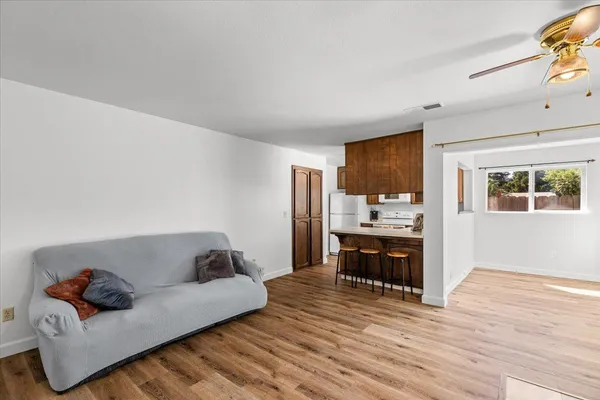 a living room with furniture and a wooden floor