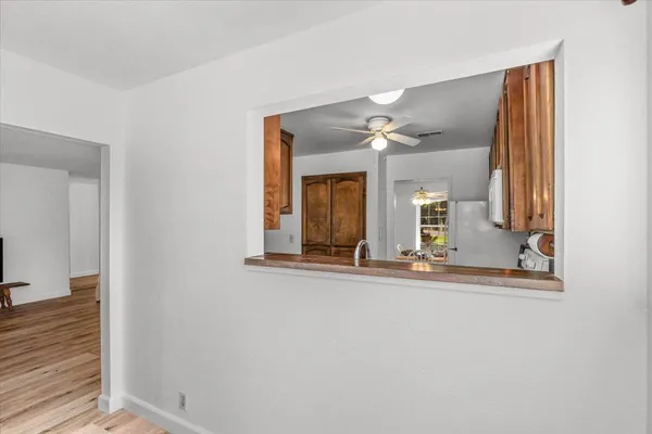 hallway with mirror and window