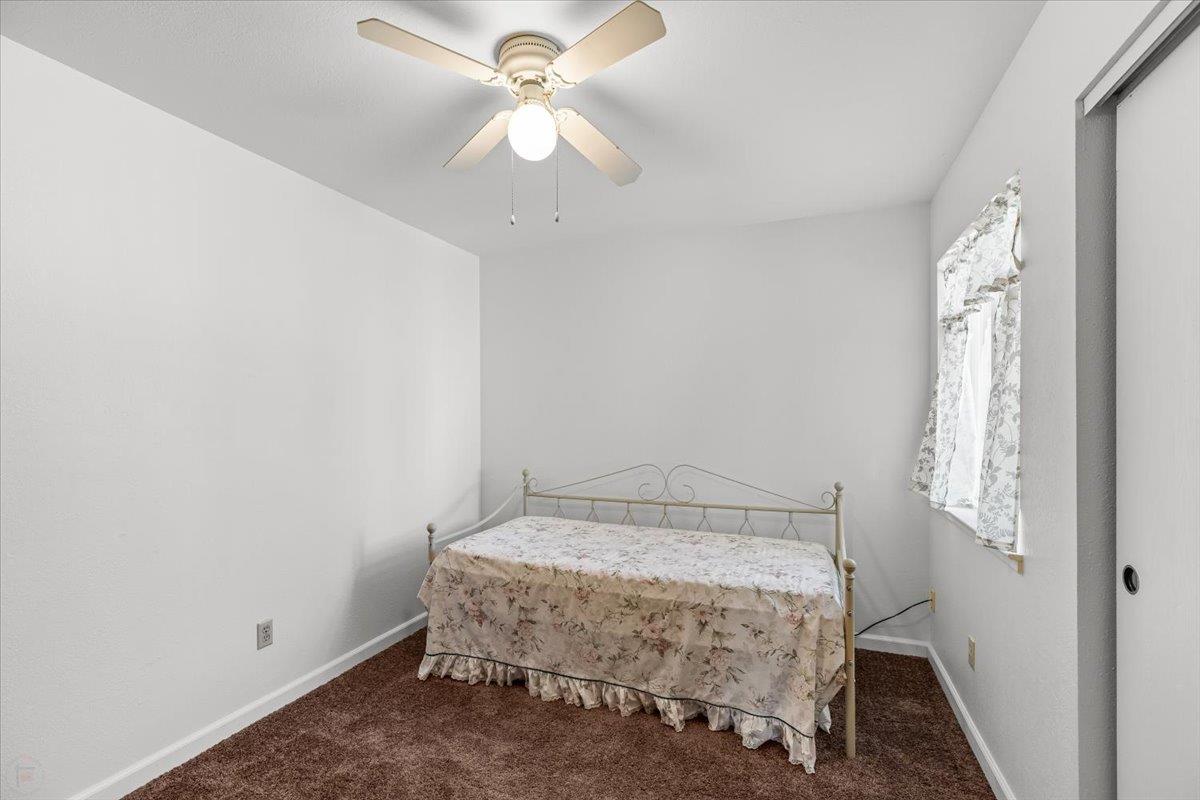 185 East Wyman Road French Camp, CA 95231 - Photo 25 of 44 a room with a bed and a chandelier