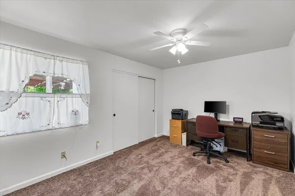 a spacious bedroom with a bed and a couch