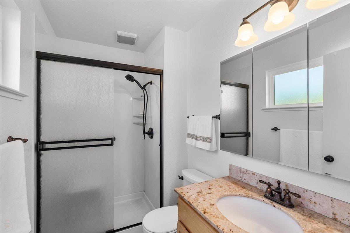 185 East Wyman Road French Camp, CA 95231 - Photo 31 of 44 a bathroom with a sink toilet and shower