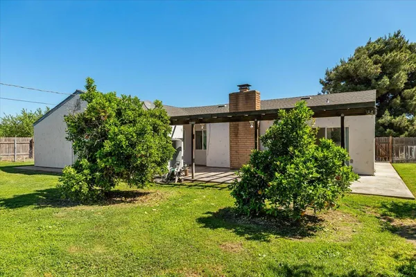 a view of a patio with table and chairs and wooden floor
